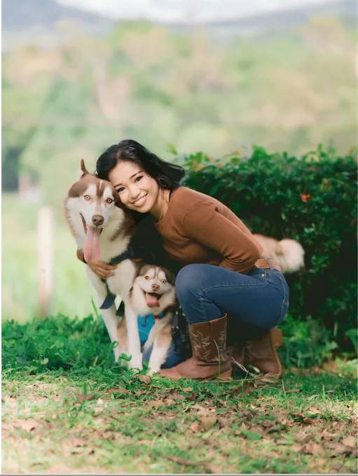 Deb Fernandez outdoors with two of her dogs